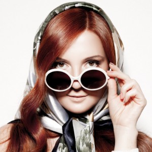 Portrait of beautiful young woman in round fashion sunglasses.